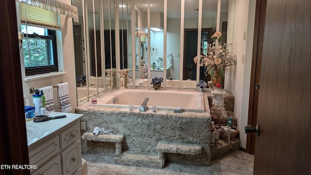 bathroom with a bath and vanity