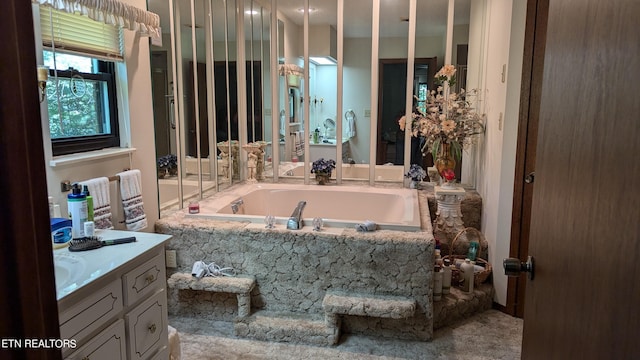 bathroom featuring a bath and vanity