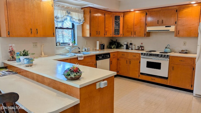 kitchen featuring light countertops, a sink, a peninsula, white appliances, and extractor fan