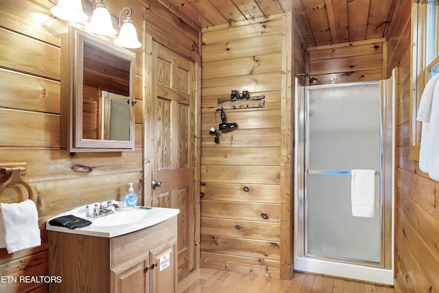 bathroom with wood ceiling, wood walls, vanity, walk in shower, and hardwood / wood-style flooring