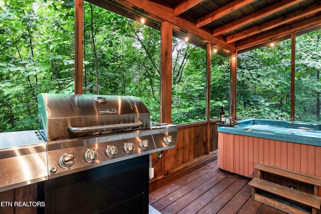 wooden deck featuring grilling area and a hot tub