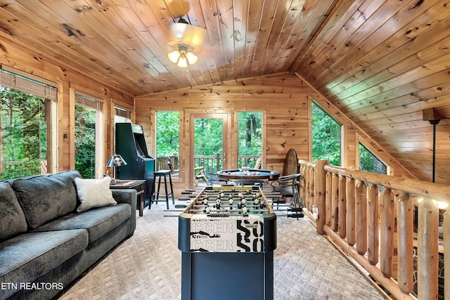 rec room with ceiling fan, wood ceiling, light colored carpet, wood walls, and lofted ceiling