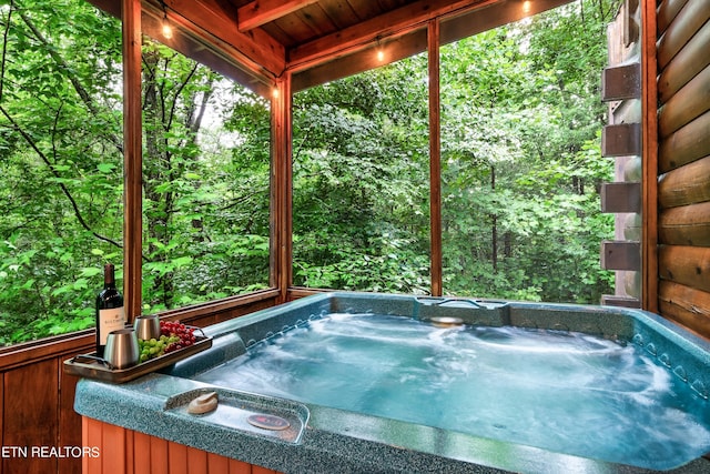 view of pool with a hot tub