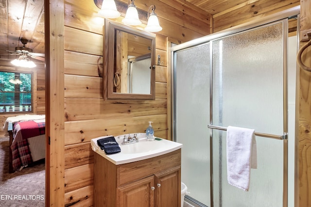 bathroom with ceiling fan, toilet, wood ceiling, wood walls, and vanity