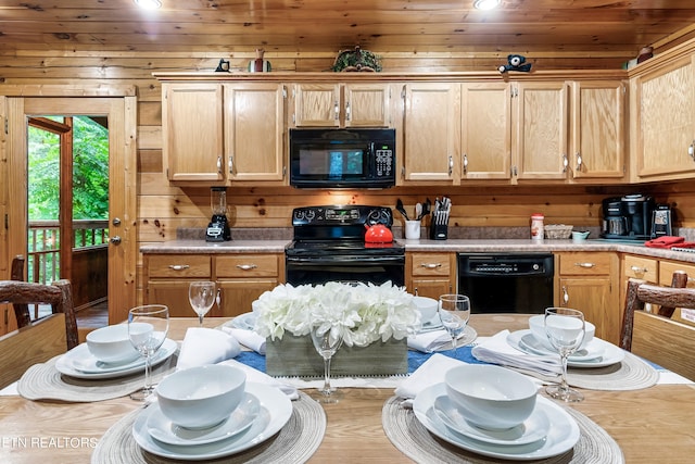 kitchen featuring wooden ceiling, wooden walls, and black appliances