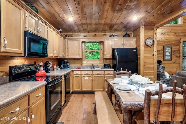 kitchen with wood walls, black appliances, light wood-type flooring, and wood ceiling