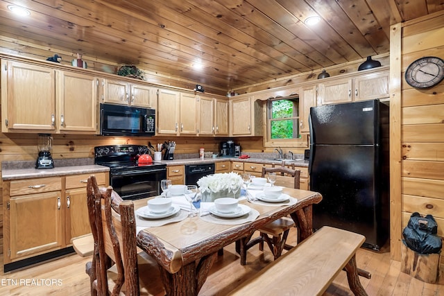 kitchen with light wood-type flooring, wood walls, black appliances, and wooden ceiling