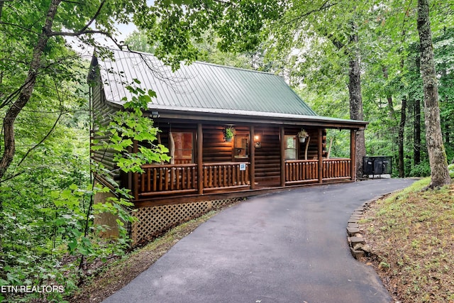 log cabin featuring a porch