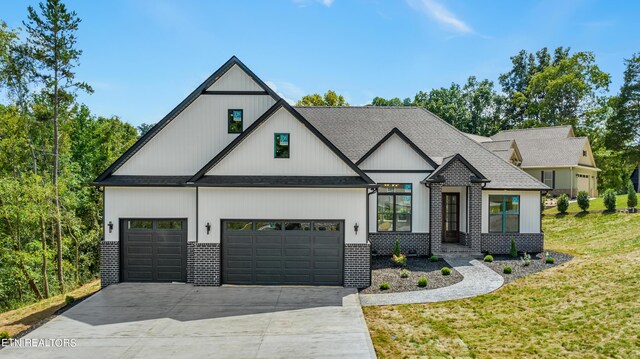 modern inspired farmhouse featuring a garage and a front lawn