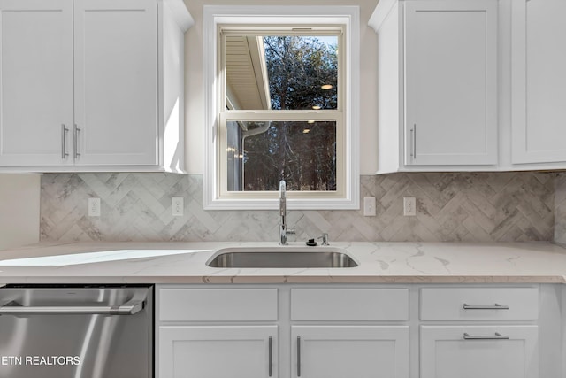 kitchen featuring white cabinetry, sink, light stone counters, and dishwasher