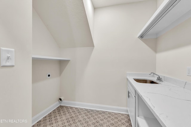 clothes washing area with sink, cabinets, and hookup for an electric dryer