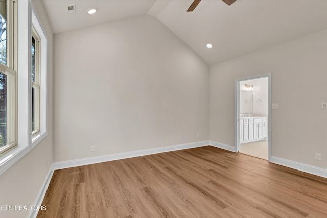 empty room featuring lofted ceiling, light hardwood / wood-style floors, and ceiling fan