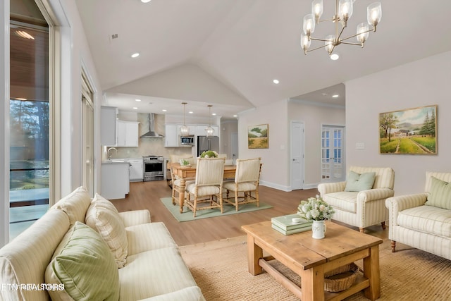 living area with lofted ceiling, light wood-style floors, recessed lighting, and a chandelier