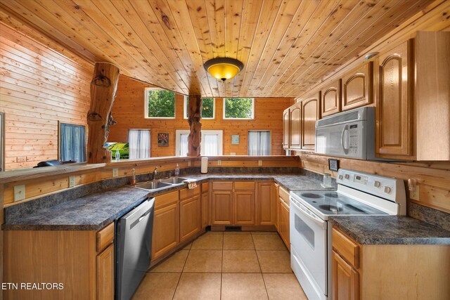 kitchen featuring wood walls, light tile patterned flooring, white appliances, and wood ceiling