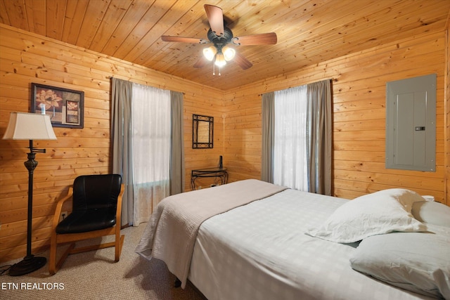 carpeted bedroom featuring ceiling fan, wooden ceiling, multiple windows, and electric panel