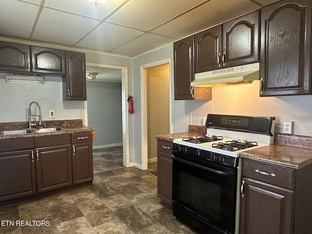 kitchen with dark brown cabinets, gas stove, a sink, and under cabinet range hood