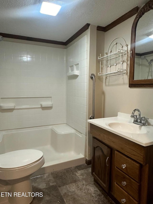 bathroom with a textured ceiling, toilet, vanity, ornamental molding, and walk in shower