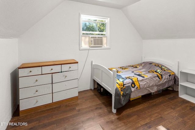 bedroom with hardwood / wood-style flooring, vaulted ceiling, and cooling unit