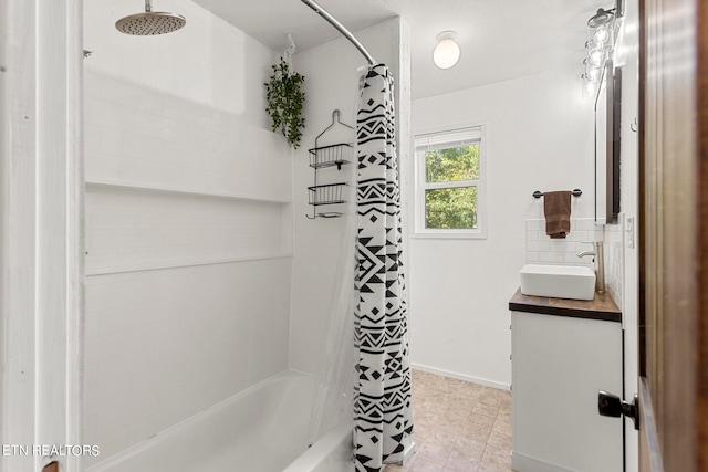 bathroom featuring tile patterned floors, shower / bath combination with curtain, and vanity