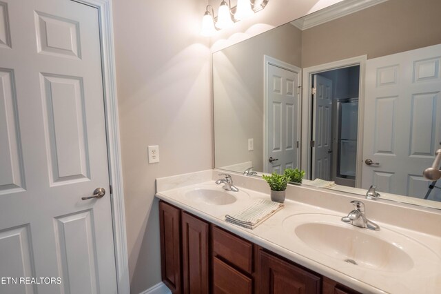 bathroom featuring crown molding and double sink vanity