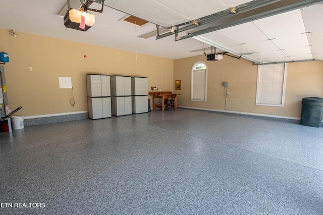 garage featuring a garage door opener and white fridge