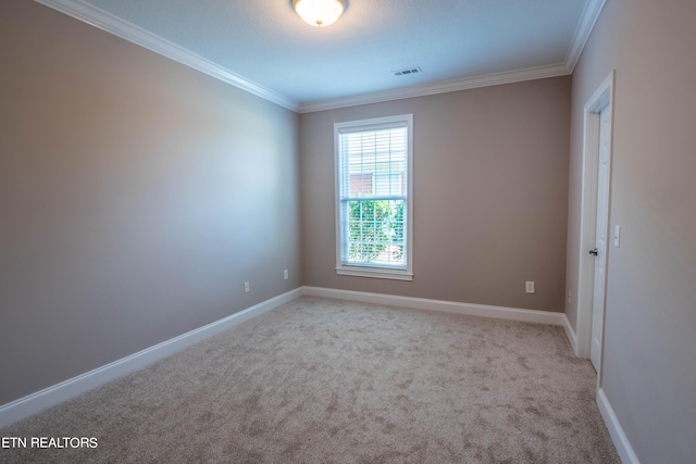 unfurnished room featuring ornamental molding and carpet flooring