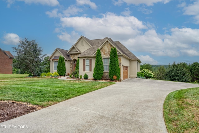 view of front of house with a garage and a front lawn