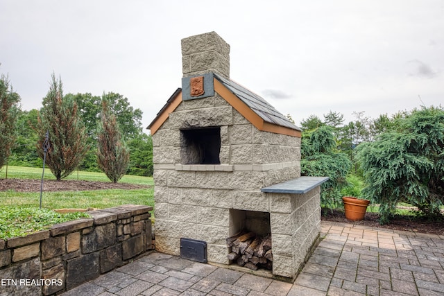 view of patio with an outdoor stone fireplace