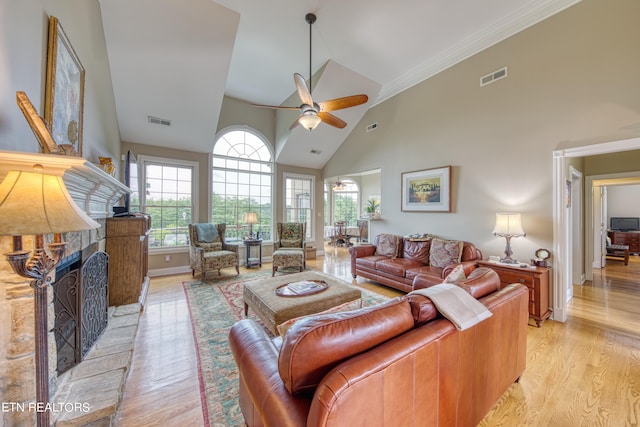 living room featuring high vaulted ceiling, ceiling fan, crown molding, and light hardwood / wood-style flooring