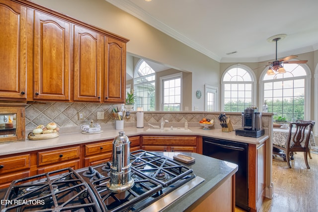 kitchen with sink, light hardwood / wood-style flooring, backsplash, dishwasher, and crown molding