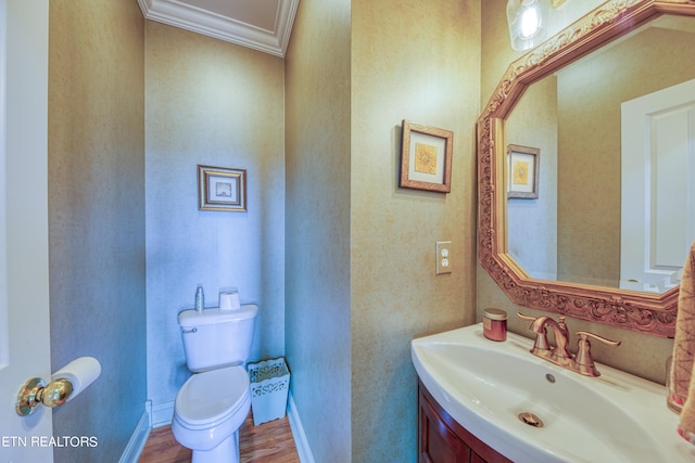 bathroom featuring vanity, crown molding, toilet, and hardwood / wood-style flooring