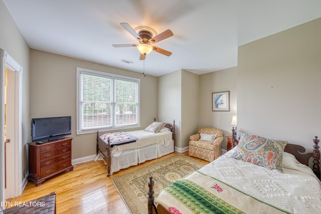 bedroom with light hardwood / wood-style flooring and ceiling fan