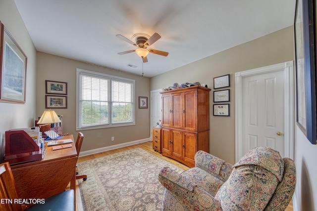 office with ceiling fan and light hardwood / wood-style flooring