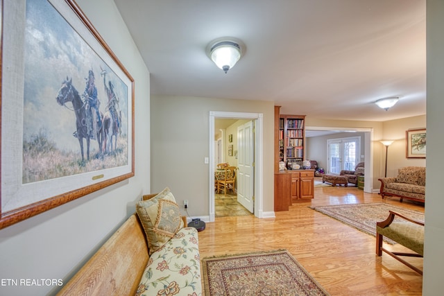 sitting room featuring french doors and light hardwood / wood-style floors