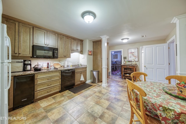 kitchen with ornate columns, black appliances, light stone counters, and sink