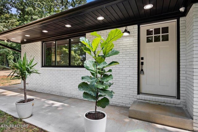 entrance to property featuring a patio area