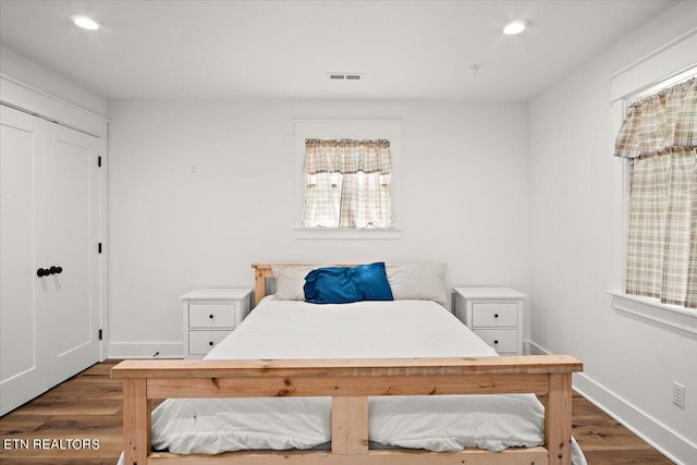 bedroom with recessed lighting, visible vents, baseboards, and dark wood finished floors