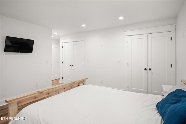 bedroom with recessed lighting and two closets