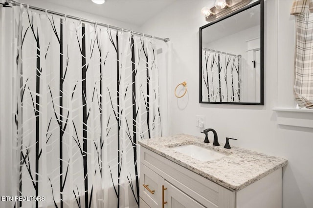 full bathroom with vanity and a shower with shower curtain