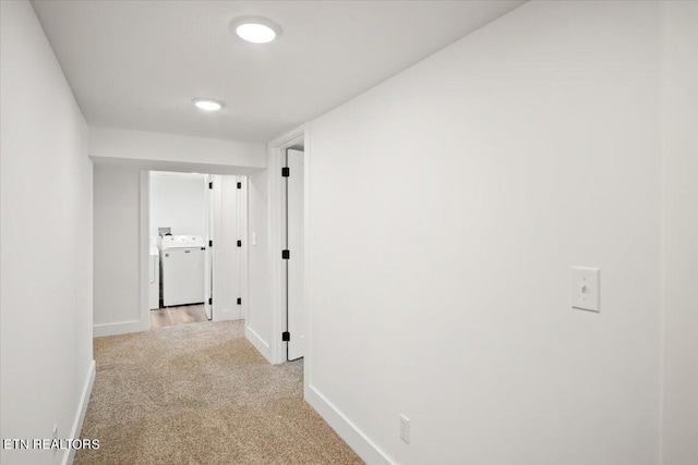 hall featuring baseboards and carpet flooring