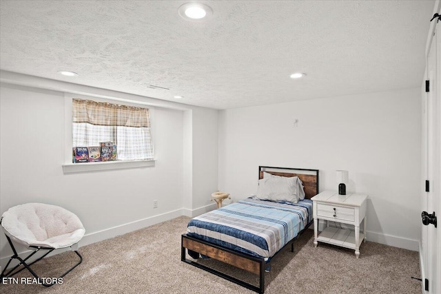 carpeted bedroom with recessed lighting, a textured ceiling, and baseboards