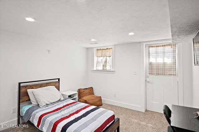 bedroom with recessed lighting, light colored carpet, baseboards, and a textured ceiling