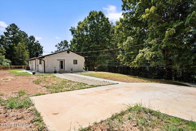 exterior space featuring fence and brick siding