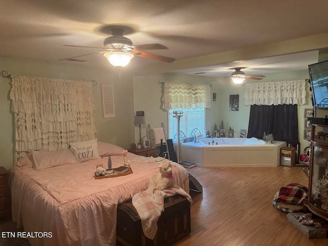 bedroom featuring a textured ceiling and wood-type flooring