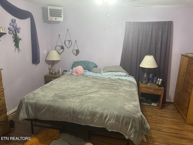 bedroom with hardwood / wood-style floors