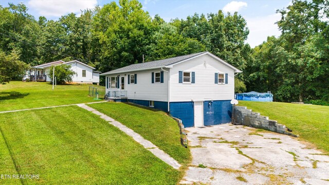 view of side of property with a lawn and a garage