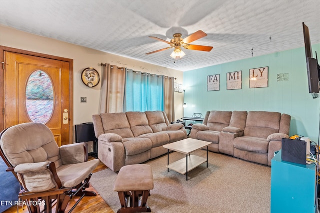 living room with ceiling fan and hardwood / wood-style flooring