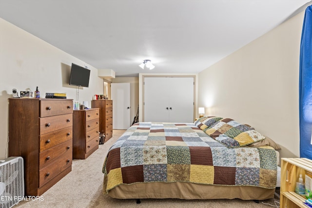 bedroom featuring light colored carpet