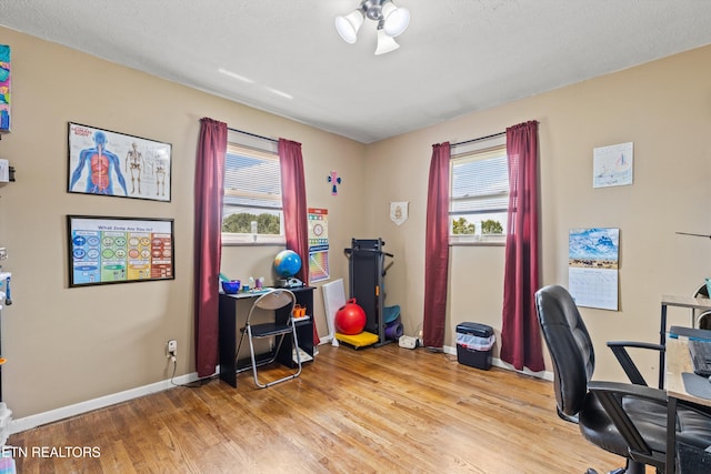 office space with light hardwood / wood-style floors and a textured ceiling