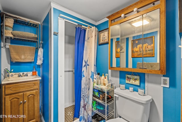 bathroom featuring tile patterned flooring, toilet, vanity, and ornamental molding